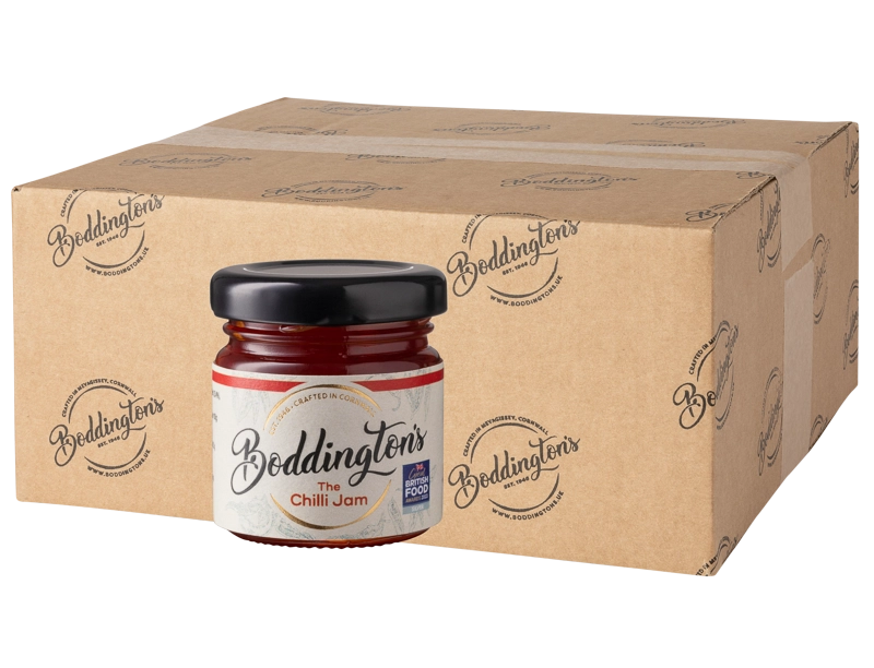 48g Mini jar of Boddingtons Chilli Jam with a cardboard box in the background